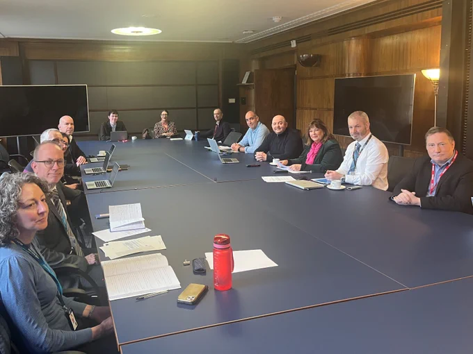 Transport Secretary Fiona Hyslop and road safety partners gathered around a table.