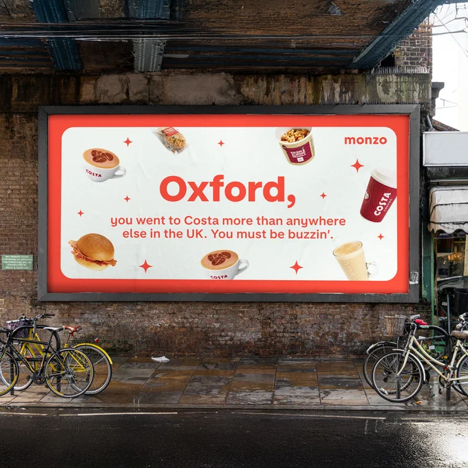 A billboard under a bridge reading: 'Oxford, you went to Costa more than anywhere else in the UK. You must be buzzin’.' Surrounded by hot drinks and coffee, and a breakfast muffin.