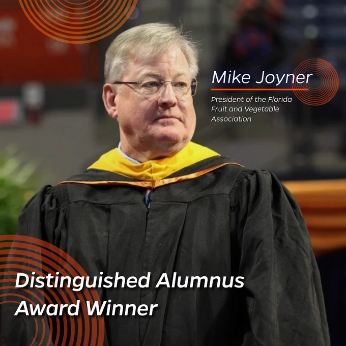 A older man stands smiling on stage at the 2024 CALS Commencement Ceremony.

"Mike Joyner"
"President of the Florida Fruit and Vegetable Association"
"Distinguished Alumnus Winner"
