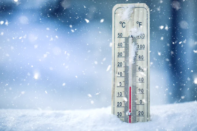 image of a thermometer in the snow, showing a low temperature
