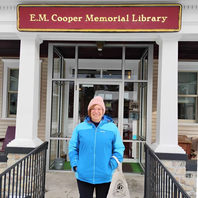 MBLC Director Amyot outside the front of the Cooper Memorial Library.