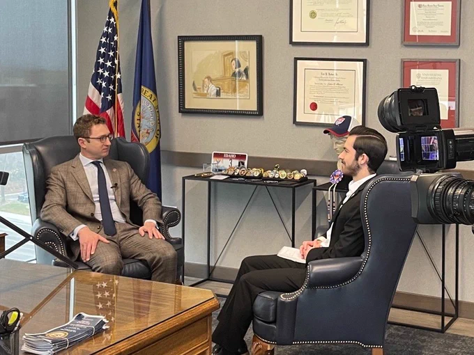 U.S. Attorney Josh Hurwit and KTVB's Jude Binkley sit in the U.S. Attorney's Office for an interview. The U.S. Flag and Idaho State Flag appear in the background along with frames on the wall.