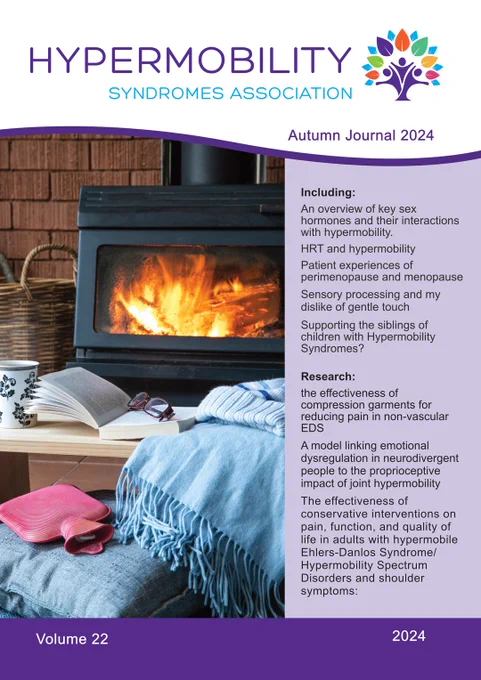 The image is the cover of the "Hypermobility Syndromes Association Autumn Journal 2024." The cover features a cozy scene with a fireplace, an open book, a pair of glasses, a mug, a blanket, and a hot water bottle. The journal's title is prominently displayed at the top, along with the volume number (Volume 22) and the year (2024) at the bottom.

The right side of the cover lists the contents of the journal, which include:

An overview of key sex hormones and their interactions with hypermobility.

HRT and hypermobility

Patient experiences of perimenopause and menopause

Sensory processing and my dislike of gentle touch

Supporting the siblings of children with Hypermobility Syndromes?

Research:

The effectiveness of compression garments for reducing pain in non-vascular EDS

A model linking emotional dysregulation in neurodivergent people to the proprioceptive impact of joint hypermobility

The effectiveness of conservative interventions on pain, function, and quality of 