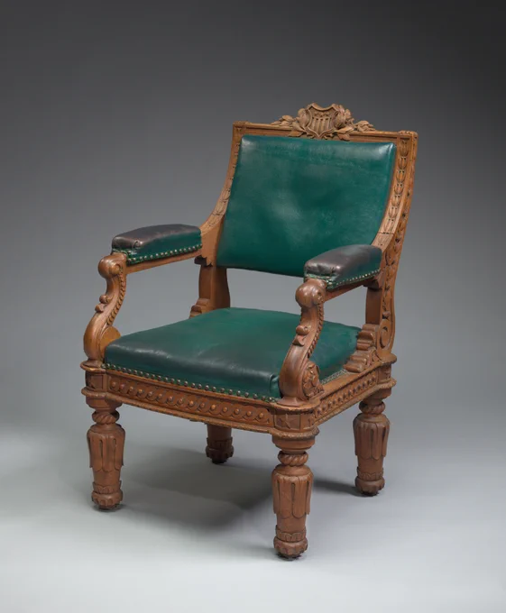 Ornate wooden chair with green upholstery