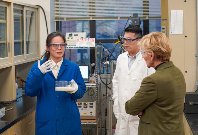 U.S. Energy Secretary Jennifer Granholm interacts with scientists in a laboratory at Ames National Laboratory.