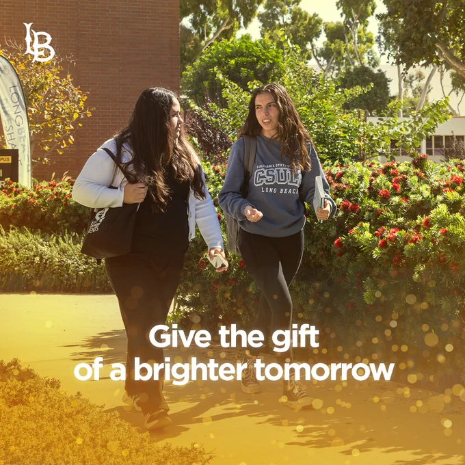 Give the gift of a brighter tomorrow. Two students walking on campus.