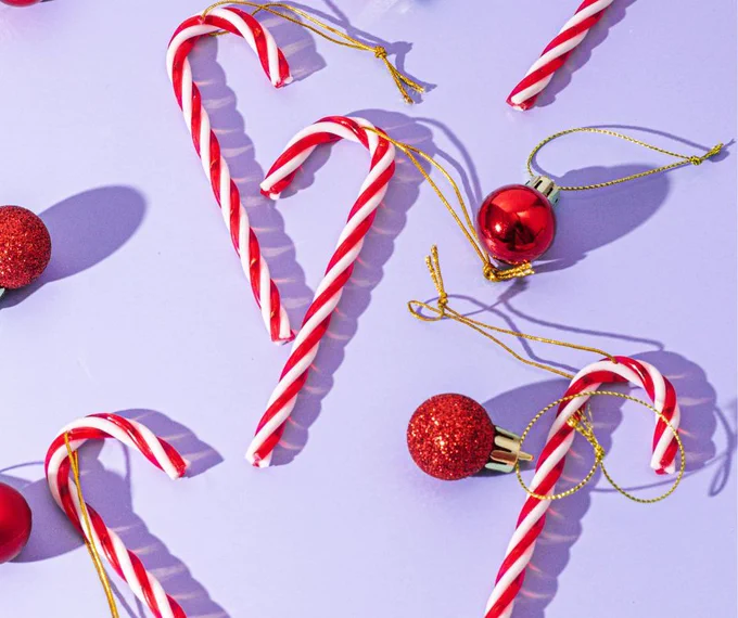 A collection of red and white candy canes and christmas ornaments