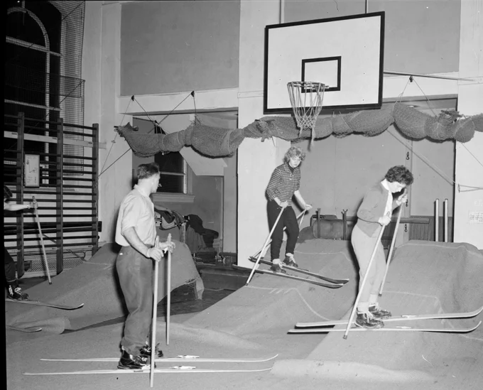 4 students on skis in the University Sports Hall.