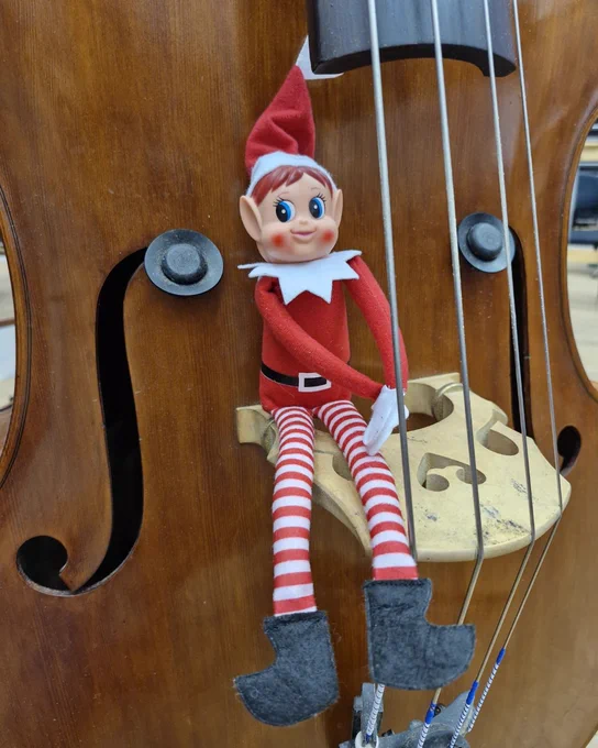 A toy elf sat on a violin 