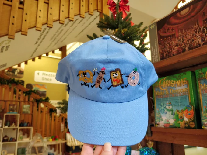 A blue hat with angry food stitched on. 