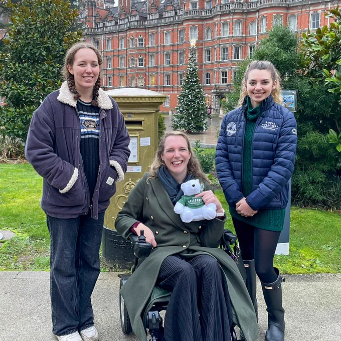 Sophie Christiansen CBE with two students in front of gold post box
