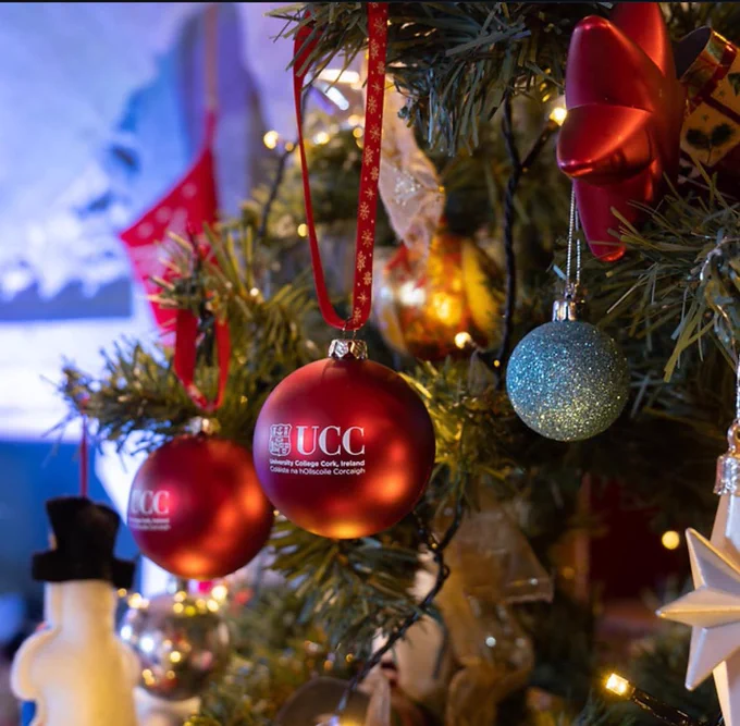 Close-up of Christmas tree in Ucc staff common room with UCC & logo branding