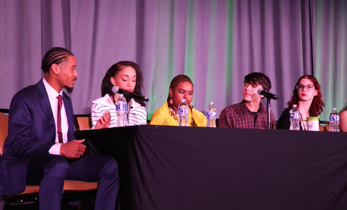 Youth panelists engaged in discussion at the National Grantee Training with five participants seated at a table.
