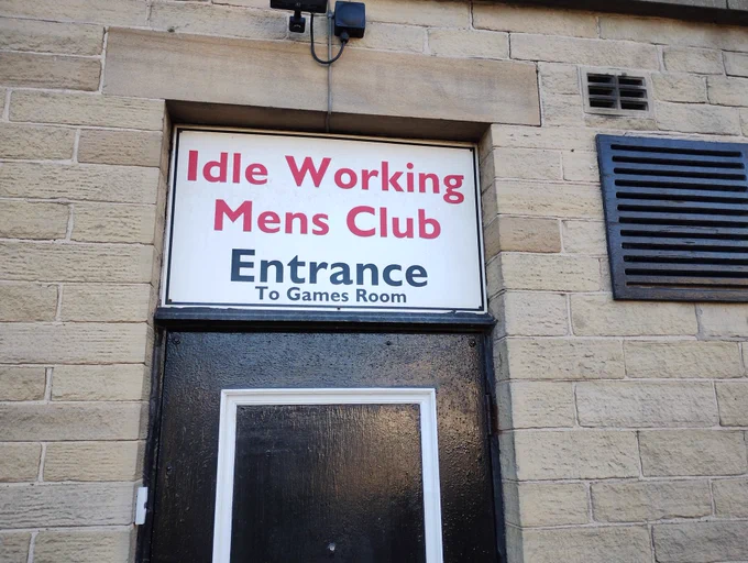 Sign above door: "Idle working mens club entrance", in smaller type "to games room"