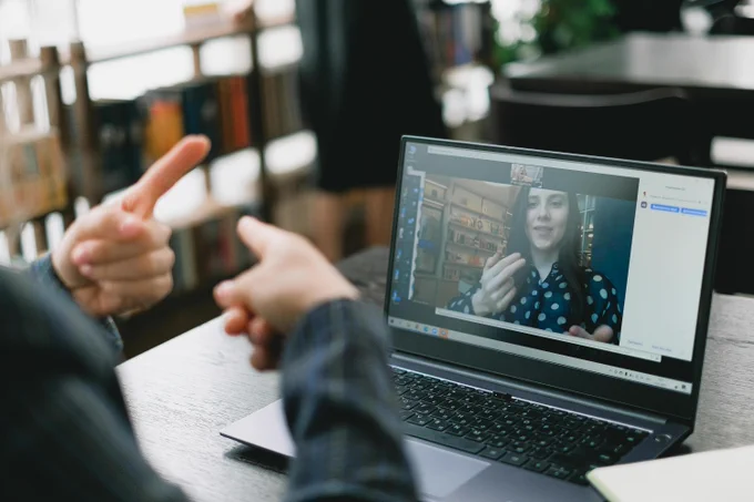 Two people talking in sign language over a video call.