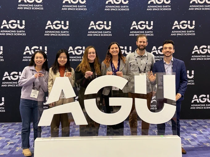 Posing with friends from UC Berkeley at the AGU sign.