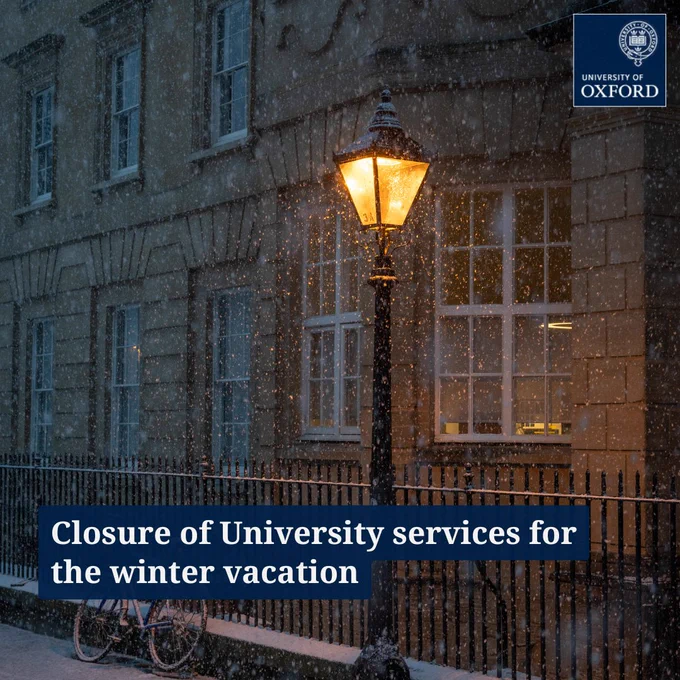 A snowy illuminated street lamp with text 'Closure of University services for the winter vacation'