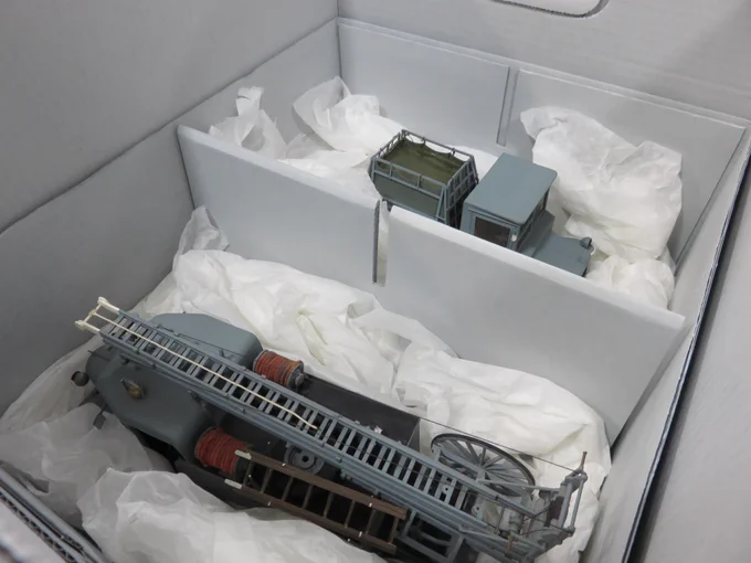 A photo of two model fire engines safely stored in boxes.