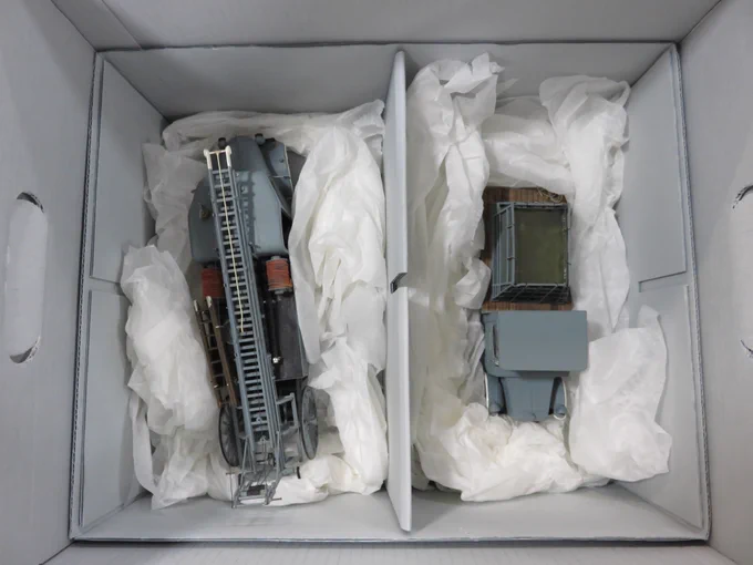 A photo of two model fire engines safely stored in boxes.