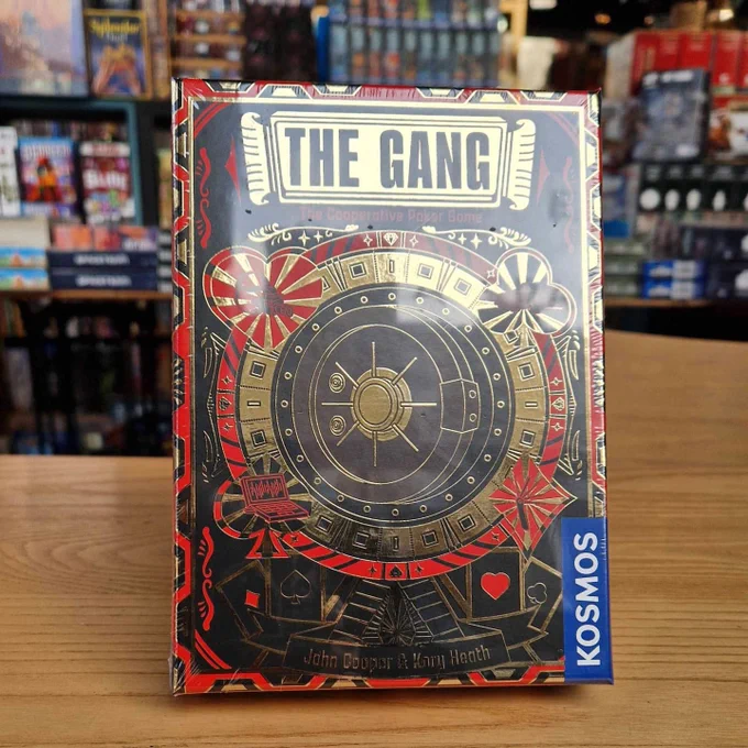 The board game the gang, with a red, black and gold illustration of a vault in the cover.