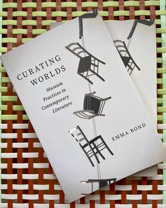 Two copies of a book entitled CURATING WORLDS