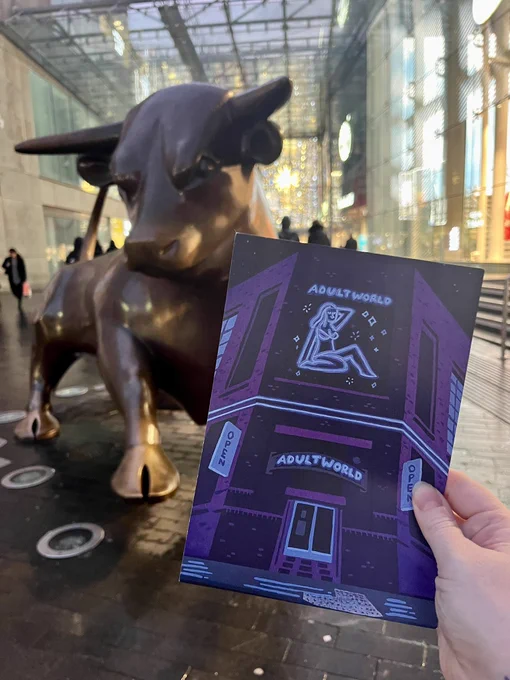 A5 print in shades of purple if Adult world building being held by a hand in front of the Birmingham bull