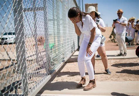 aoc in all white miles away from a texas detention center dry-crying for a flock of gathered propagandists