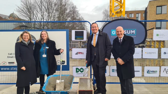 A picture of two women and two men stood in front of the building site at Royal Hampshire County Hospital 