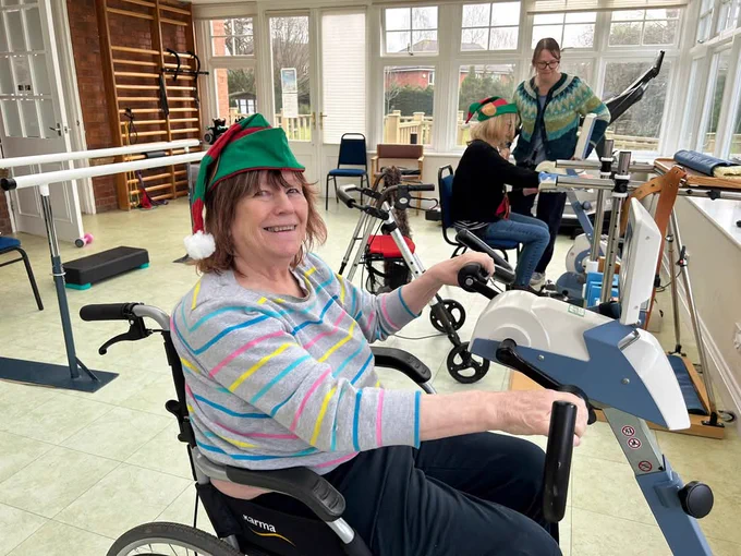 Member Jane using the recumbent bike in physiotherapy 