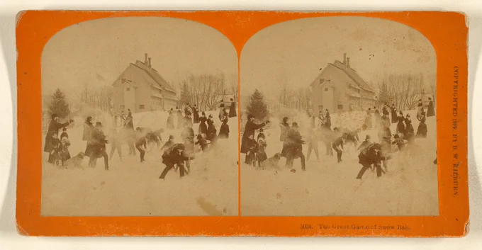 Photo of people playing in the snow in front of a building