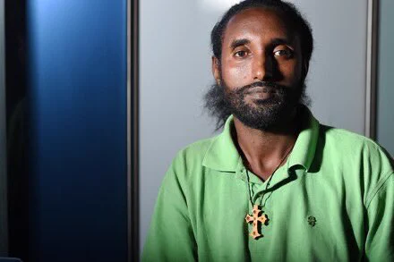 Abreham Zemedagegehu, who is deaf, poses for a portrait at Akin Gump law firm in Washington on Sept. 21, 2015. He is being represented pro bono by Akin Gump in a lawsuit he filed alleging neglect in the Arlington County, Va., jail. (Matt McClain/The Washington Post)