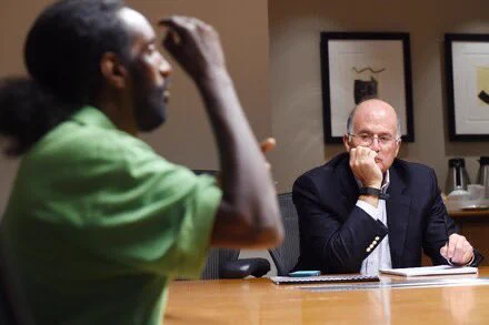 Abreham Zemedagegehu, left, is interviewed by his attorney, Larry E. Tanenbaum, a partner at Akin Gump who is representing Zemedagegehu pro bono in his lawsuit against the sheriff of Arlington County, Va. (Matt McClain/The Washington Post)