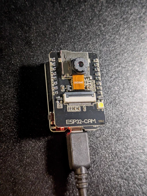A tiny board with camera module (the ESP32-CAM)
