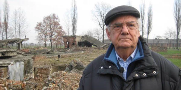 A phot of an Italian Jew, Shlomo Venezia, forced to work in the Sonderkommando at Auschwitz., He is standing in front of the ruins of the gas chambers at Auschwitz-Birkenau.
