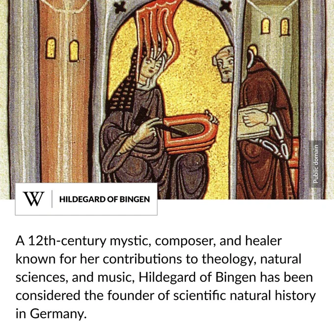 A painting of a woman in a black robe seated on a chair below an archway. Text says: A 12th-century mystic, composer, and healer known for her contributions to theology, natural sciences, and music, Hildegard of Bingen has been considered the founder of scientific natural history in Germany.