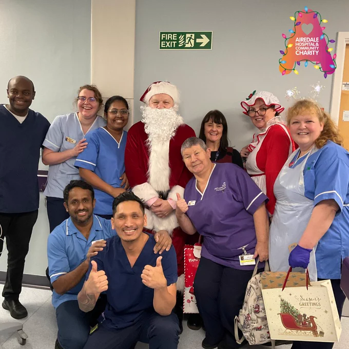 Image of a group of people posing with Santa and Mrs Claus
