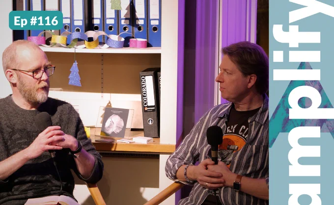 Writer Tim Rutherford-Johnson in conversation with composer Ian Wilson. The amplify logo and episode number are overlaid at the edges of the photograph.