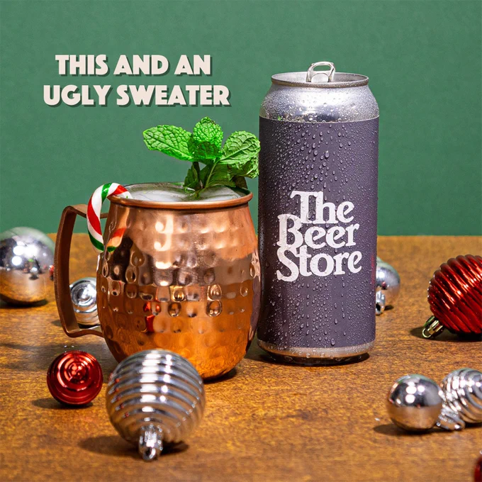 Peppermint beer mule in a copper mug beside a Beer Store beer can and holiday ornaments. Copy reads: This and an ugly sweater.