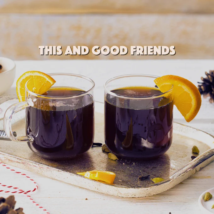 Two mulled beers on a tray with orange slices garnishes. Copy reads: This and good friends. 