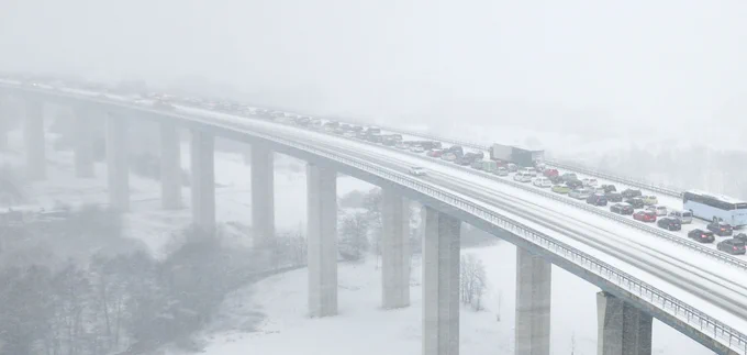 Highway bridge during a heavy snowfall. (Credit: iStock).
