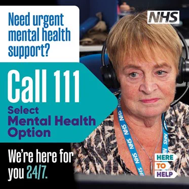 A female NHS worker wearing a headset with the wording "Need urgent mental health support? Call 111, select mental health option. We're here for you 24/7. Here to Help."