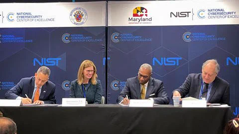 Left to right: Deputy Secretary of Commerce Don Graves, Under Secretary of Commerce for Standards and Technology and NIST Director Laurie E. Locascio, Maryland Secretary of Commerce Kevin Anderson, and Montgomery County Executive Marc Elrich sign a partnership agreement at the NIST National Cybersecurity Center of Excellence in 2023.