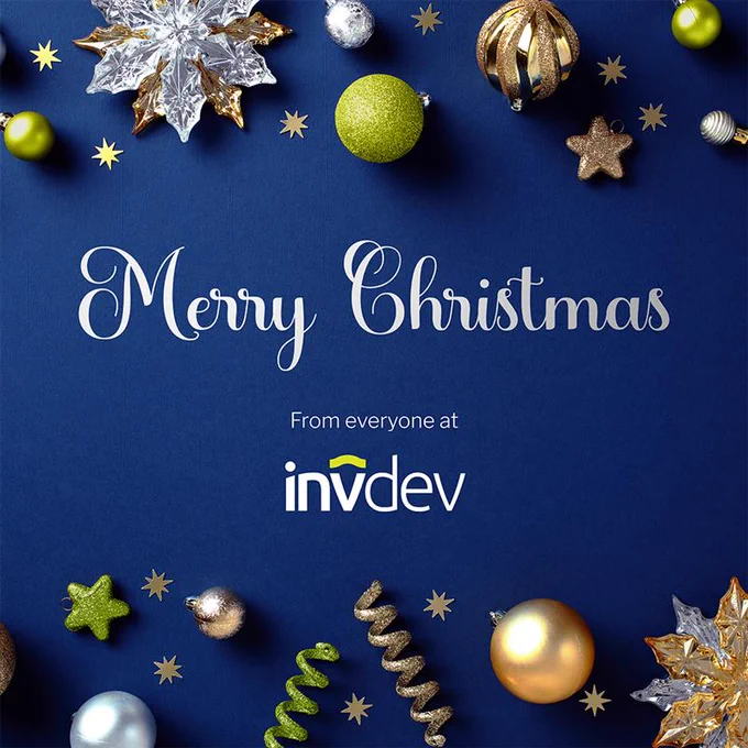 Christmas baubles decorating a table. 'Merry Christmas, from everyone at INV Group.' is written in the middle in white font.