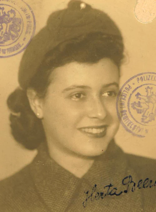 Vintage passport-style photo of a woman with a beret, featuring official stamps.