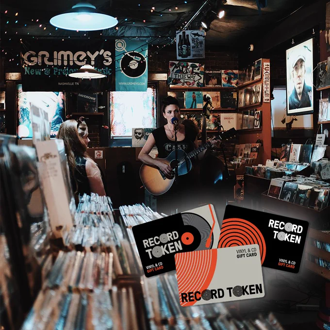 A record store with a live performer. The record store is decorated with festive fairy lights. In the bottom right hand corner of the image, three Record Tokens are featured.