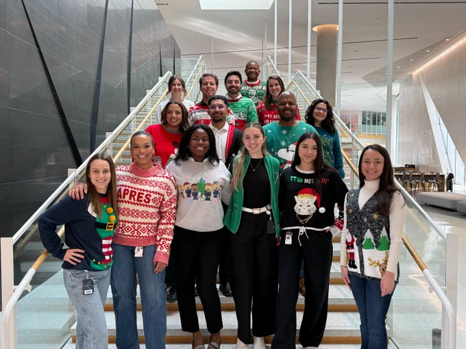 Oracle employees in a group shot wearing ugly holiday sweaters