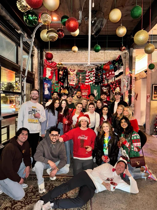 Oracle employees in a group shot wearing ugly holiday sweaters