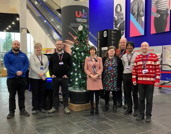 The Library of Birmingham business and learning team posing next to the reception Christmas tree.