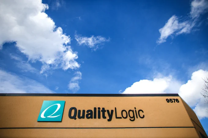 QualityLogic building under a blue sky