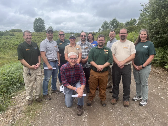 Gov. Evers poses for a group photo on the trail with DNR staff. 